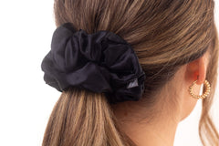 Black mulberry silk hair scrunchie in woman's hair. The r and r collective.