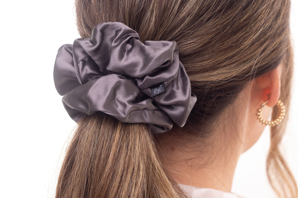 Grey mulberry silk hair scrunchie in woman's hair. The r and r collective.