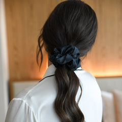 Black mulberry silk hair scrunchie in woman's hair. The r and r collective.