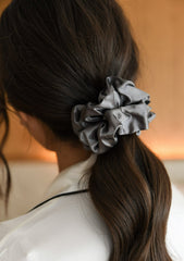 Large grey mulberry silk hair scrunchie in woman's hair. The r and r collective.