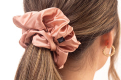 Rose gold mulberry silk hair scrunchie in woman's hair. The r and r collective.