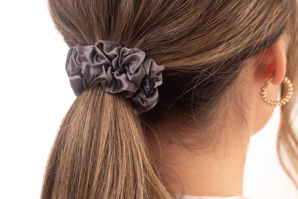 Medium grey silk hair scrunchie in woman's hair. The r and r collective.